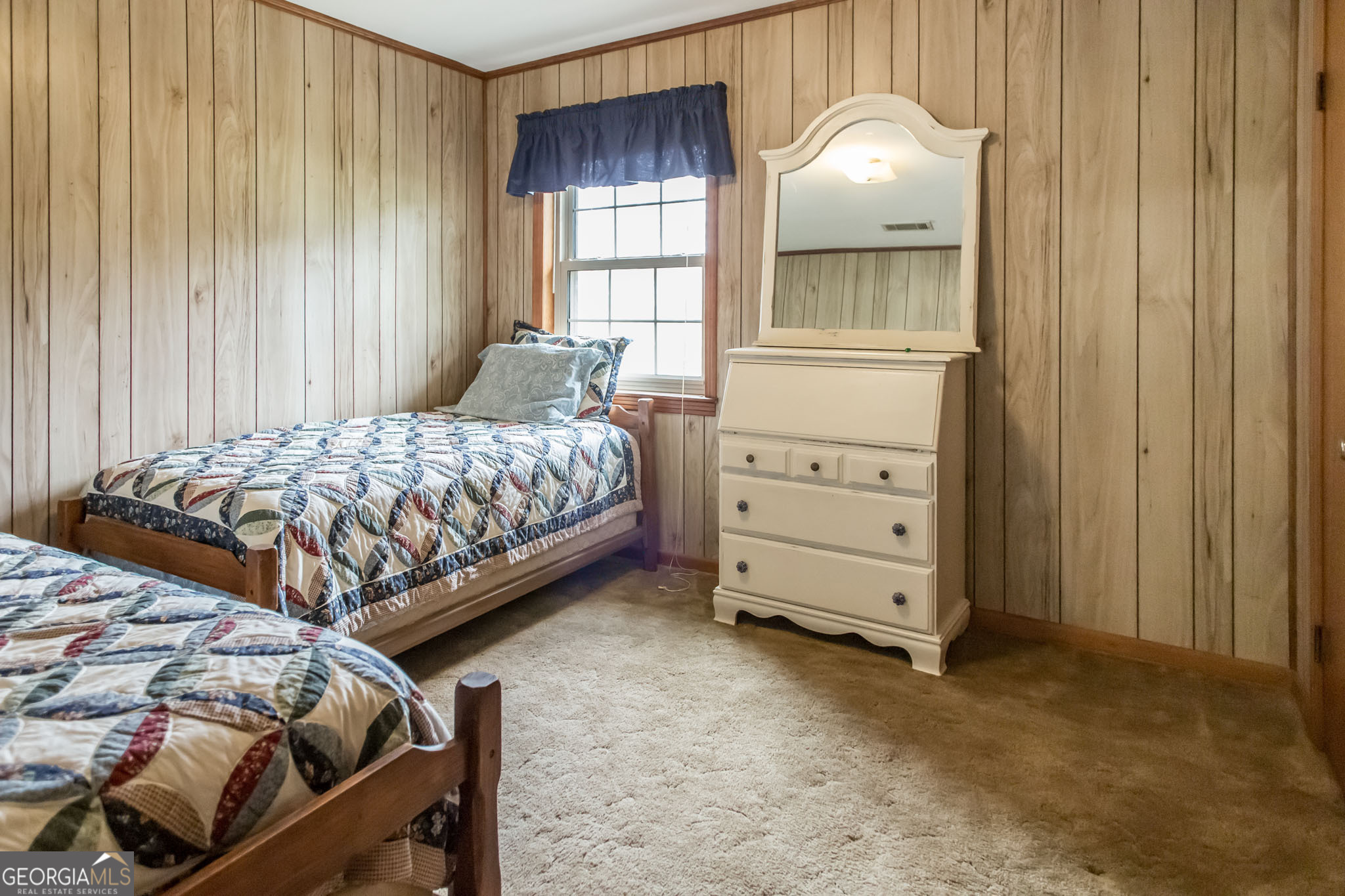 1917 Gilchrist Avenue Waycross, GA 31503 - Photo 31 of 42 a bedroom with a bed and a dresser