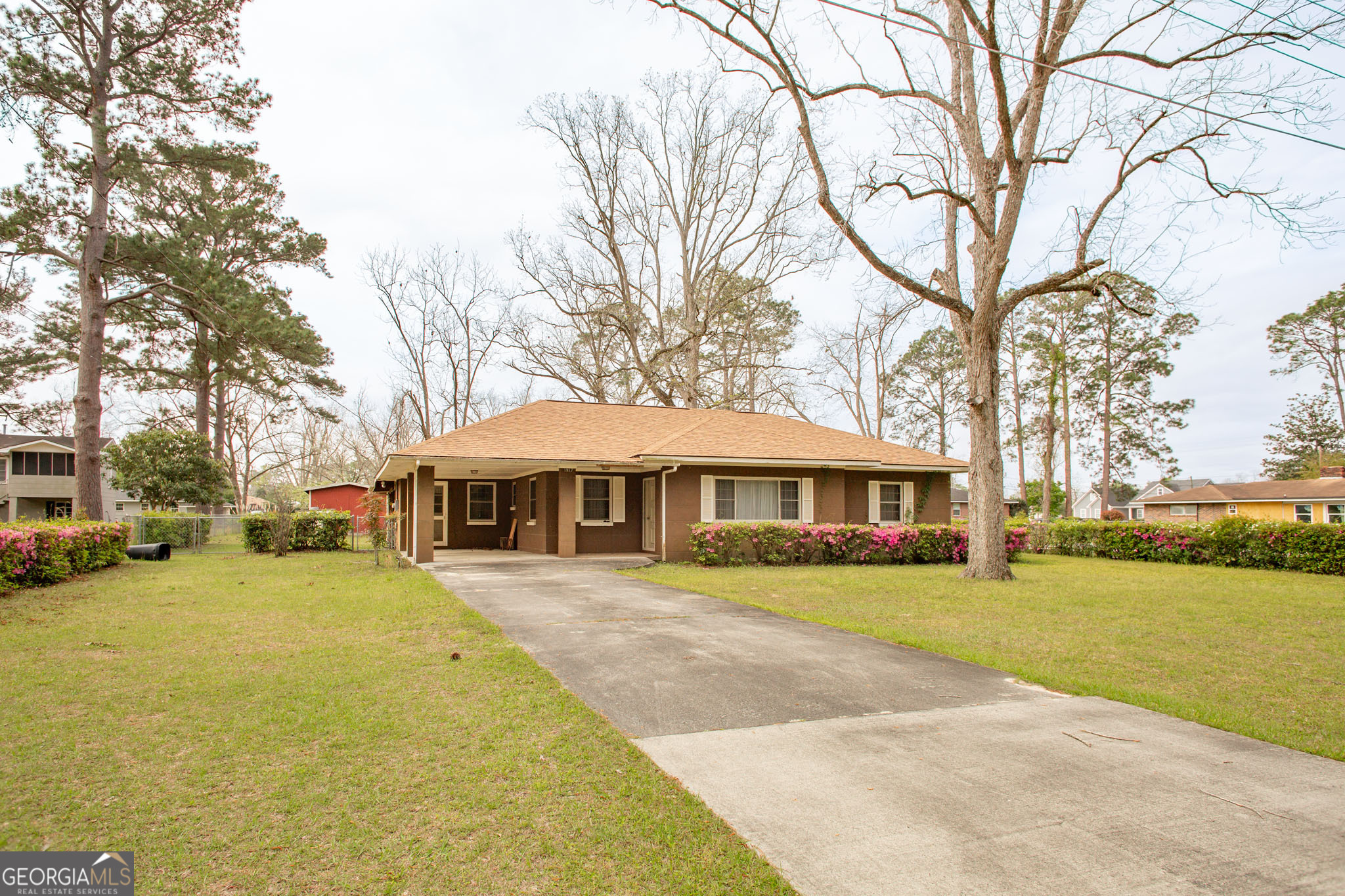 1917 Gilchrist Avenue Waycross, GA 31503 - Photo 4 of 42 a front view of a building with a garden and trees