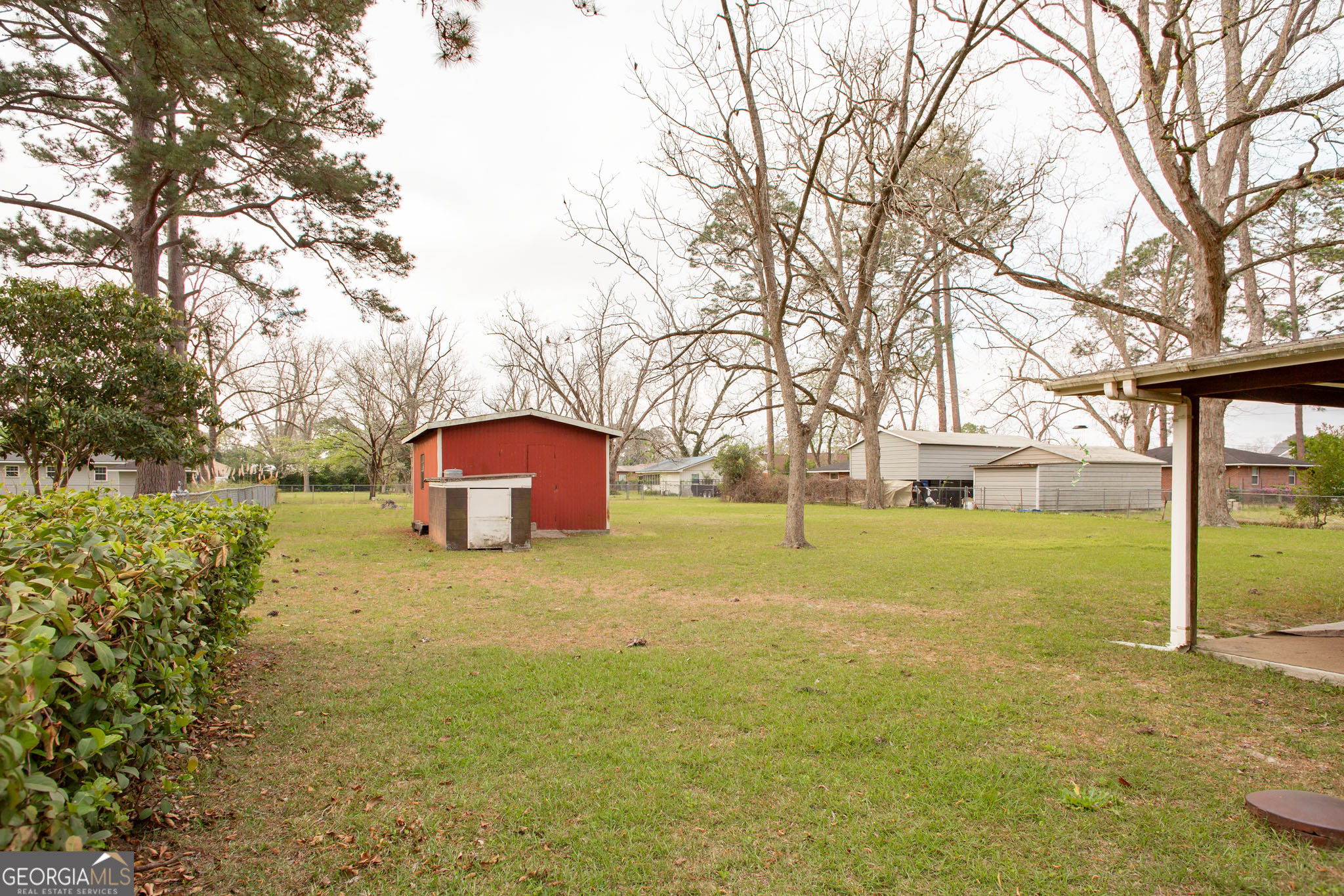 1917 Gilchrist Avenue Waycross, GA 31503 - Photo 41 of 42 a yellow house with trees in front of it
