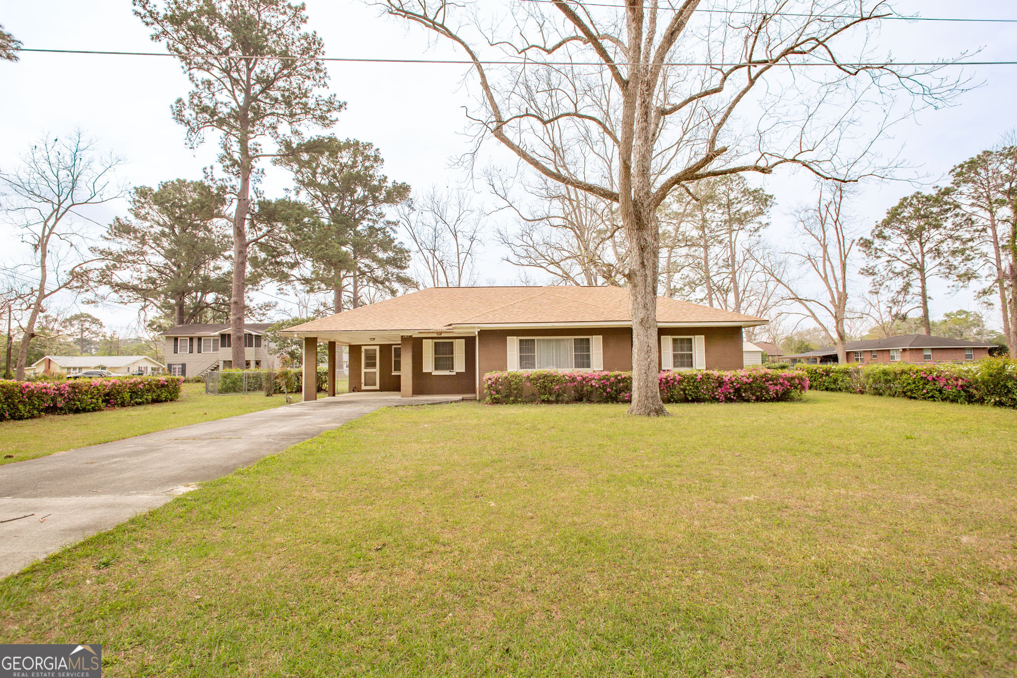 1917 Gilchrist Avenue Waycross, GA 31503 - Photo 5 of 42 a front view of a building with a garden and swimming pool