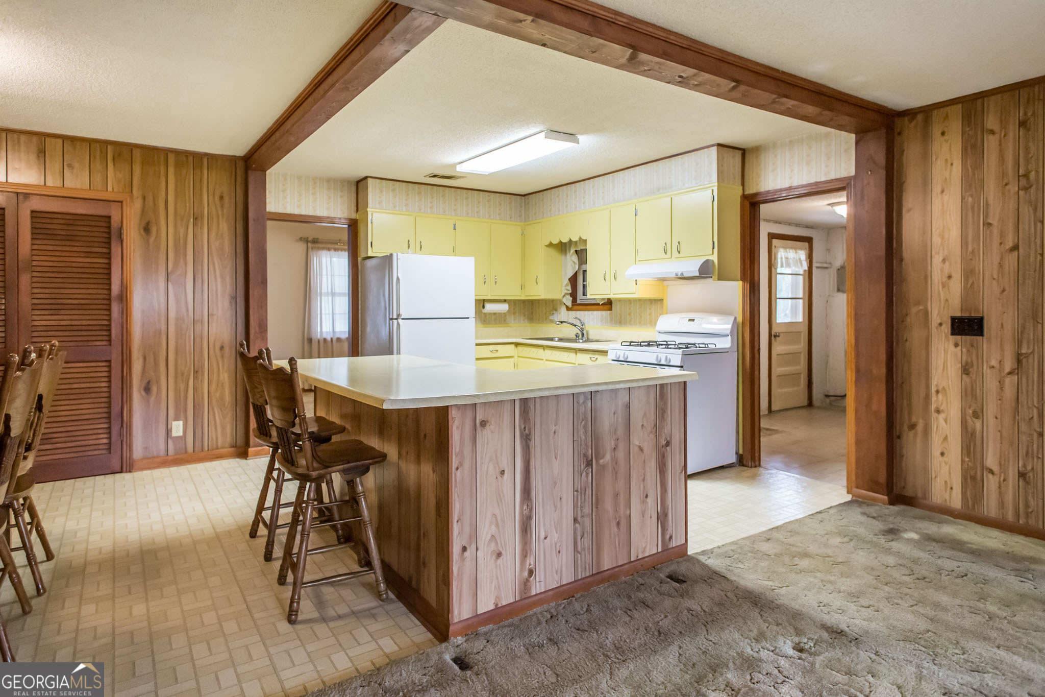 1917 Gilchrist Avenue Waycross, GA 31503 - Photo 10 of 42 a kitchen with a table chairs refrigerator and cabinets
