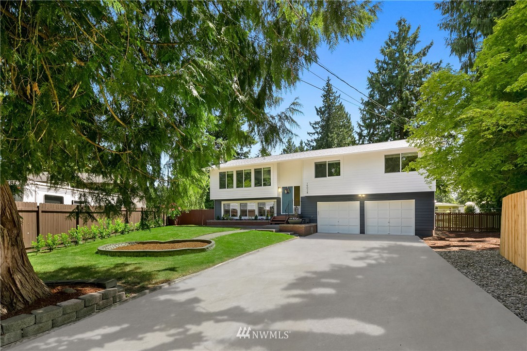 19024 2nd Avenue Southeast Bothell, WA 98012 - Photo 1 of 2 a front view of a house with a yard and trees