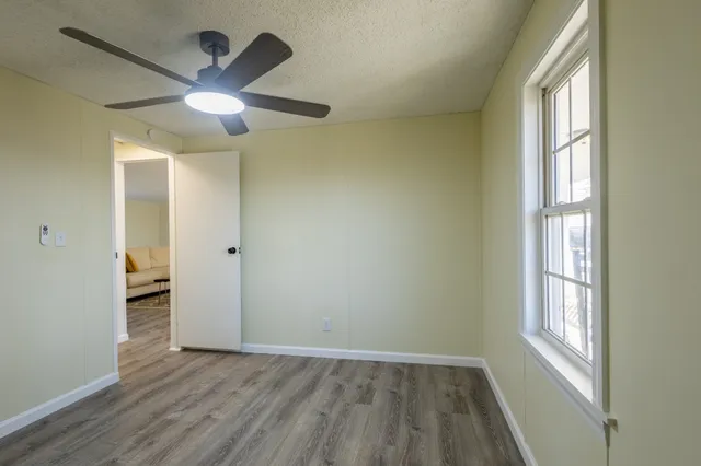 wooden floor in an empty room with a window