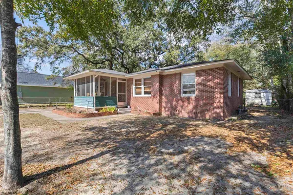a view of a house with backyard and a tree