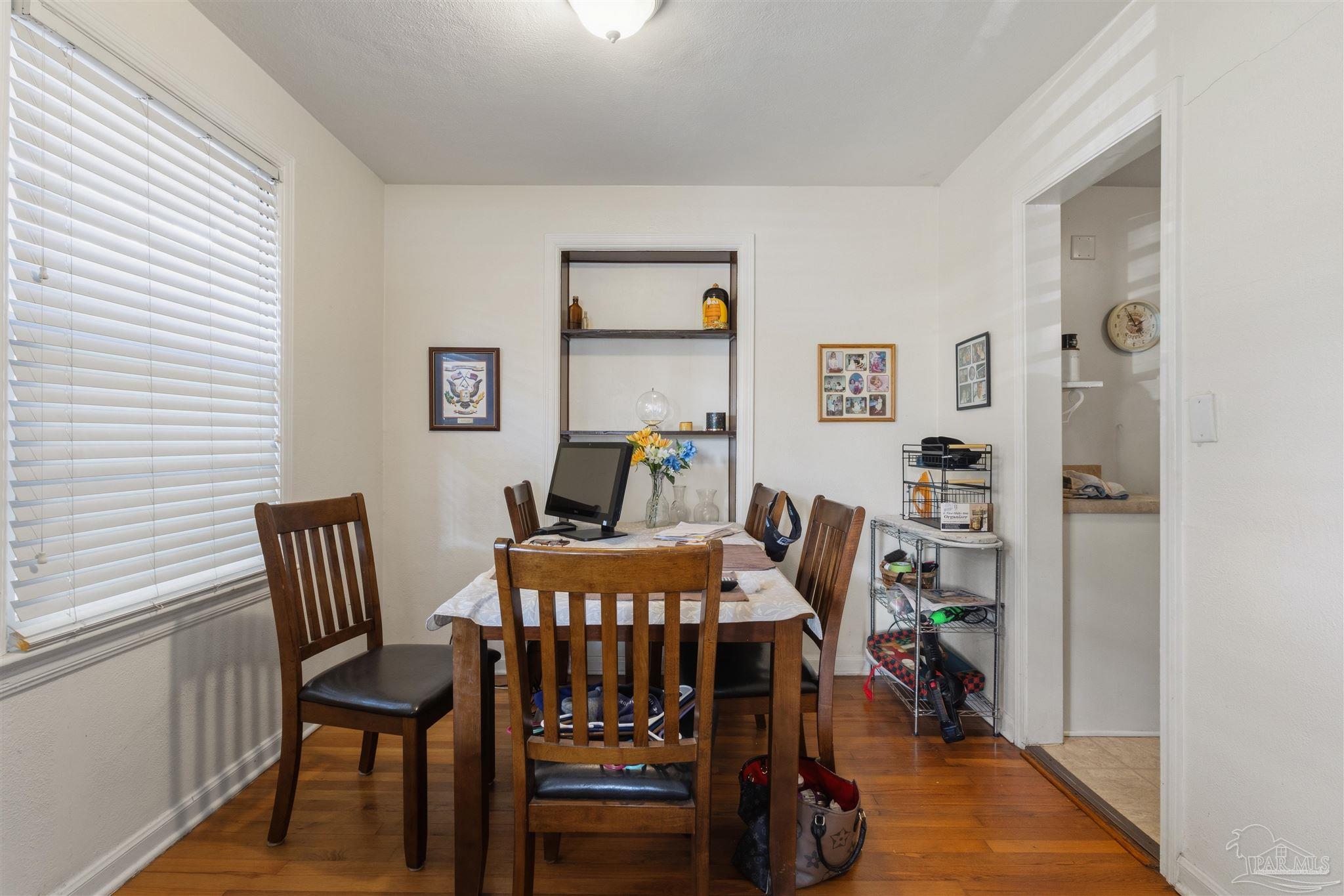 116 Rue Max Street Pensacola, FL 32507 - Photo 14 of 20 a view of a dining room with furniture and wooden floor