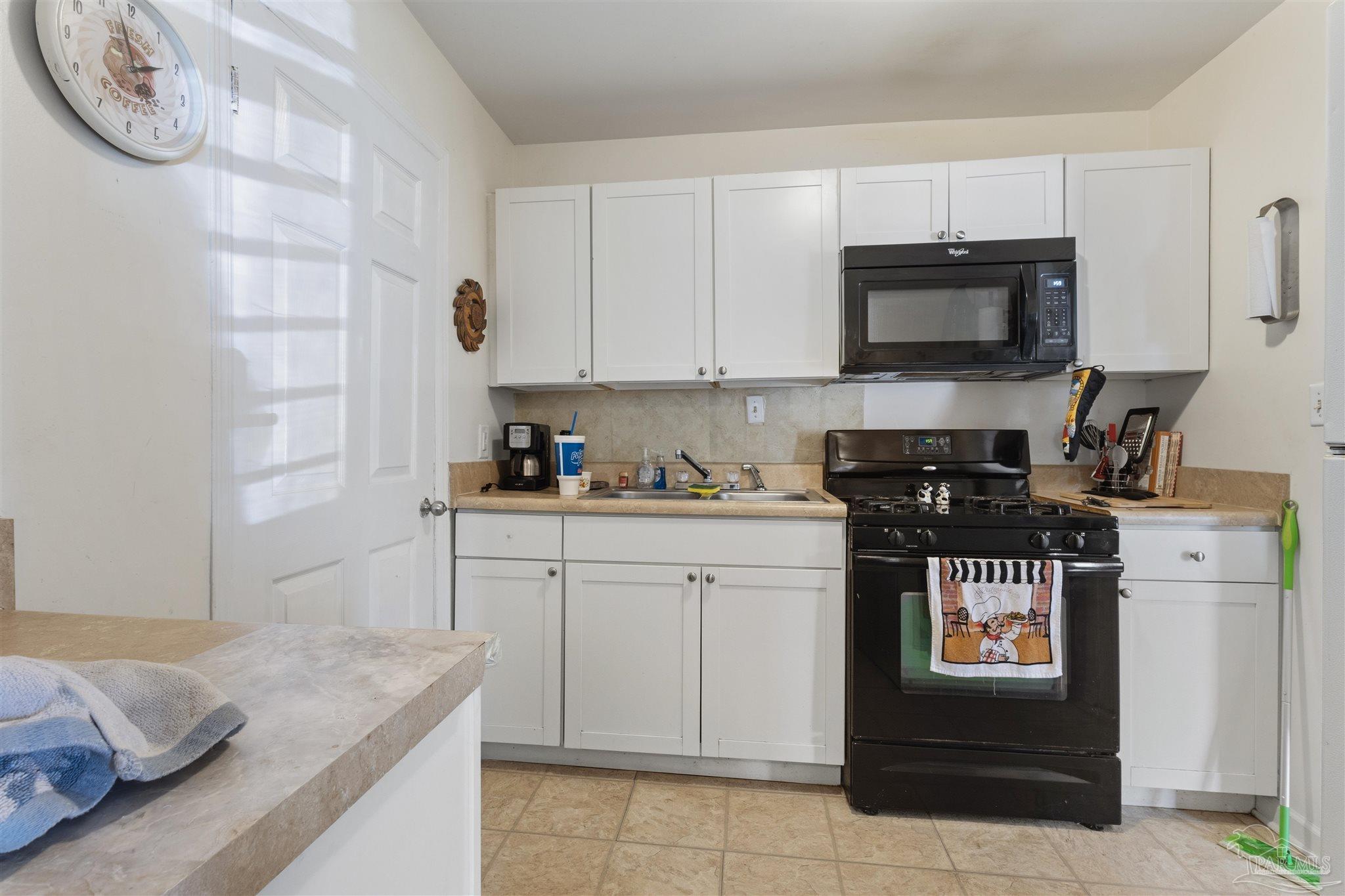 116 Rue Max Street Pensacola, FL 32507 - Photo 4 of 20 a kitchen with granite countertop white cabinets and stainless steel appliances