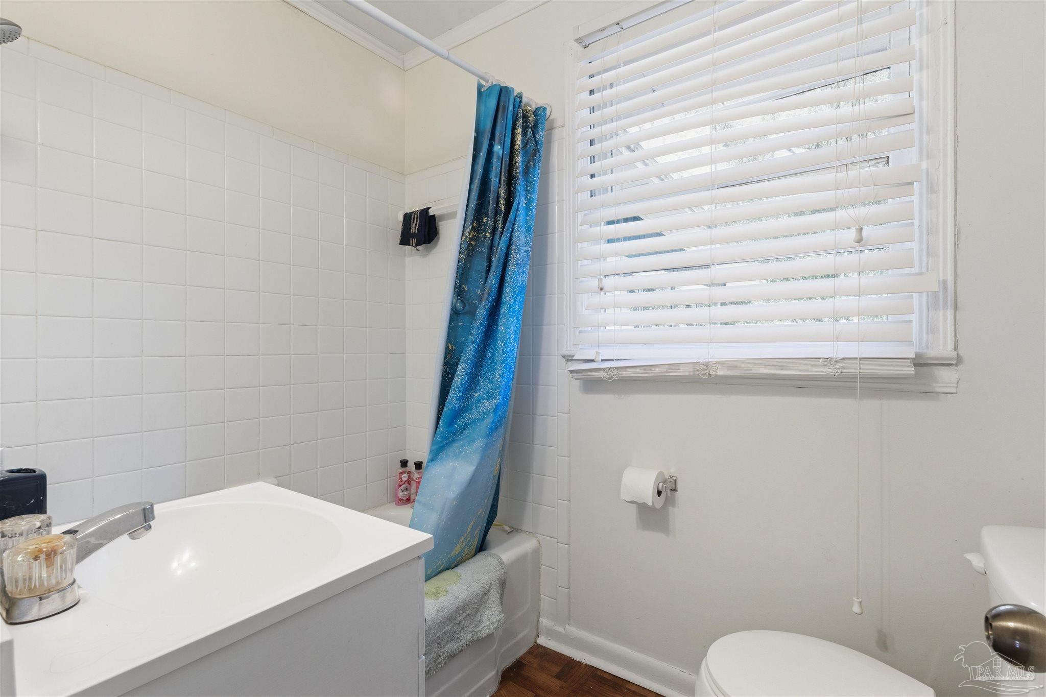 116 Rue Max Street Pensacola, FL 32507 - Photo 6 of 20 a bathroom with a sink a toilet and a mirror