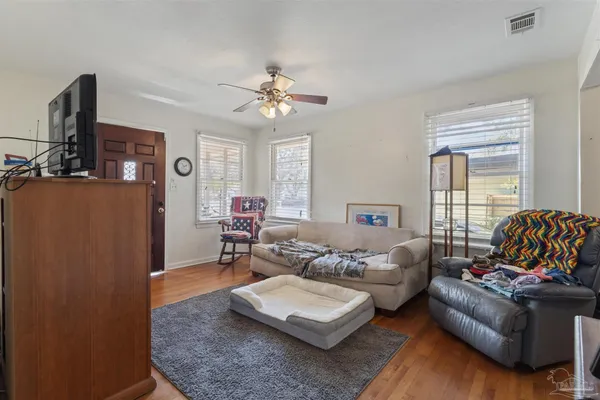 a living room with furniture rug and window