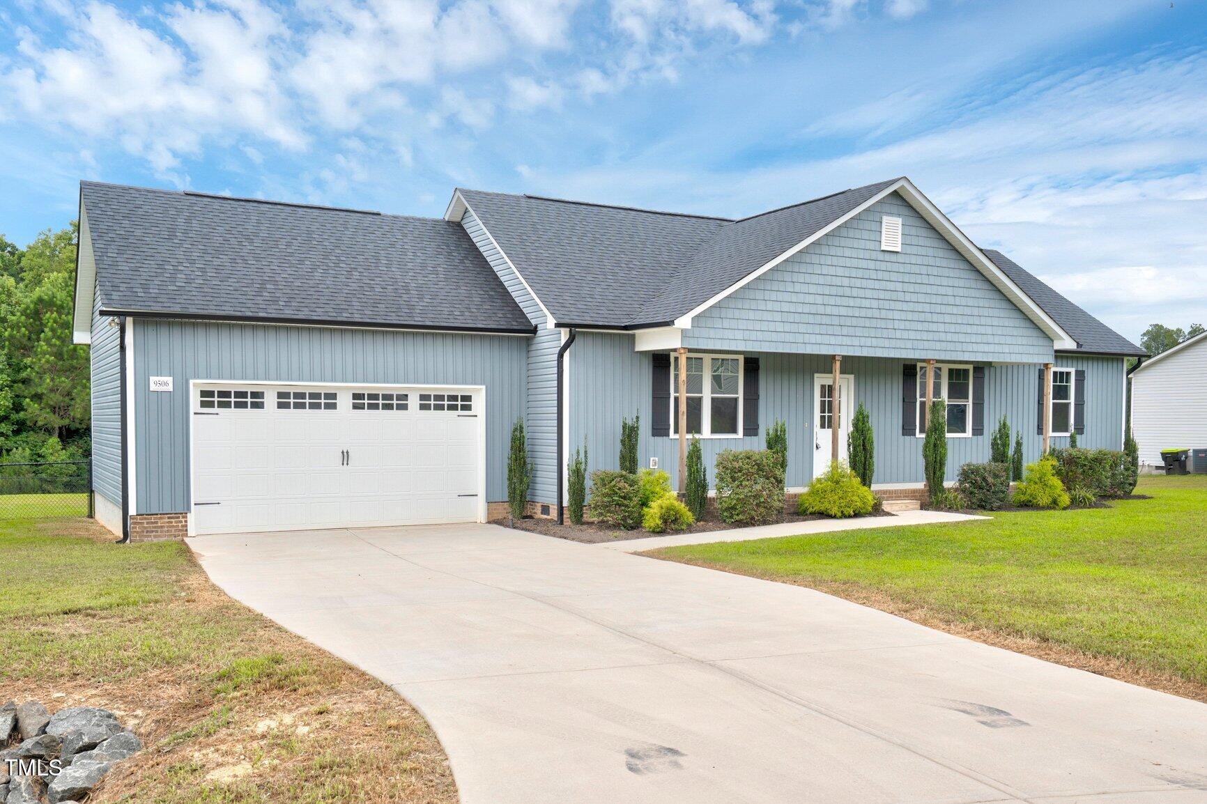 9506 South Beaver Crk Way Middlesex, NC 27557 - Photo 1 of 28 a front view of a house with a yard and garage