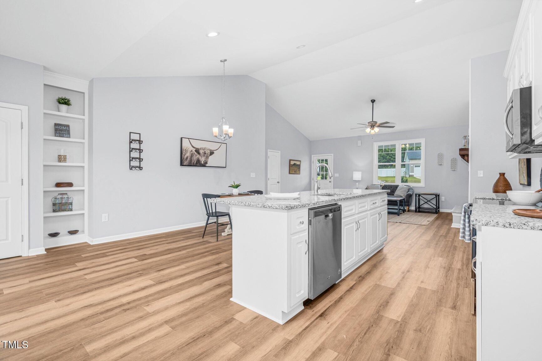 9506 South Beaver Crk Way Middlesex, NC 27557 - Photo 11 of 28 a kitchen with stainless steel appliances granite countertop a stove and a sink