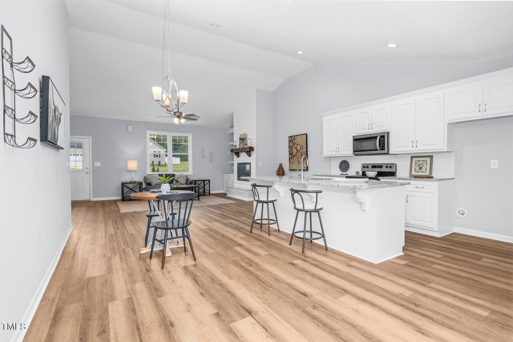 9506 South Beaver Crk Way Middlesex, NC 27557 - Photo 12 of 28 a living room with furniture a dining table and kitchen view