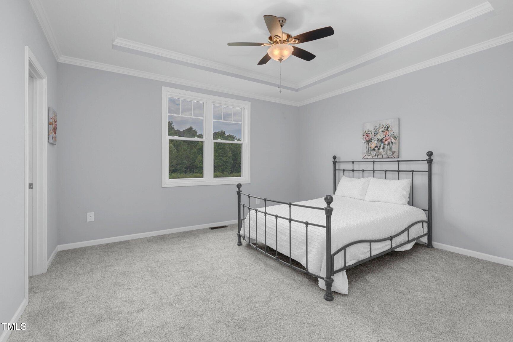 9506 South Beaver Crk Way Middlesex, NC 27557 - Photo 20 of 28 a spacious bedroom with a bed and a window