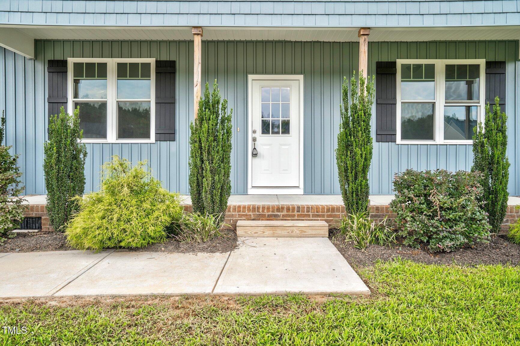 9506 South Beaver Crk Way Middlesex, NC 27557 - Photo 4 of 28 a view of entrance of house and potted plants