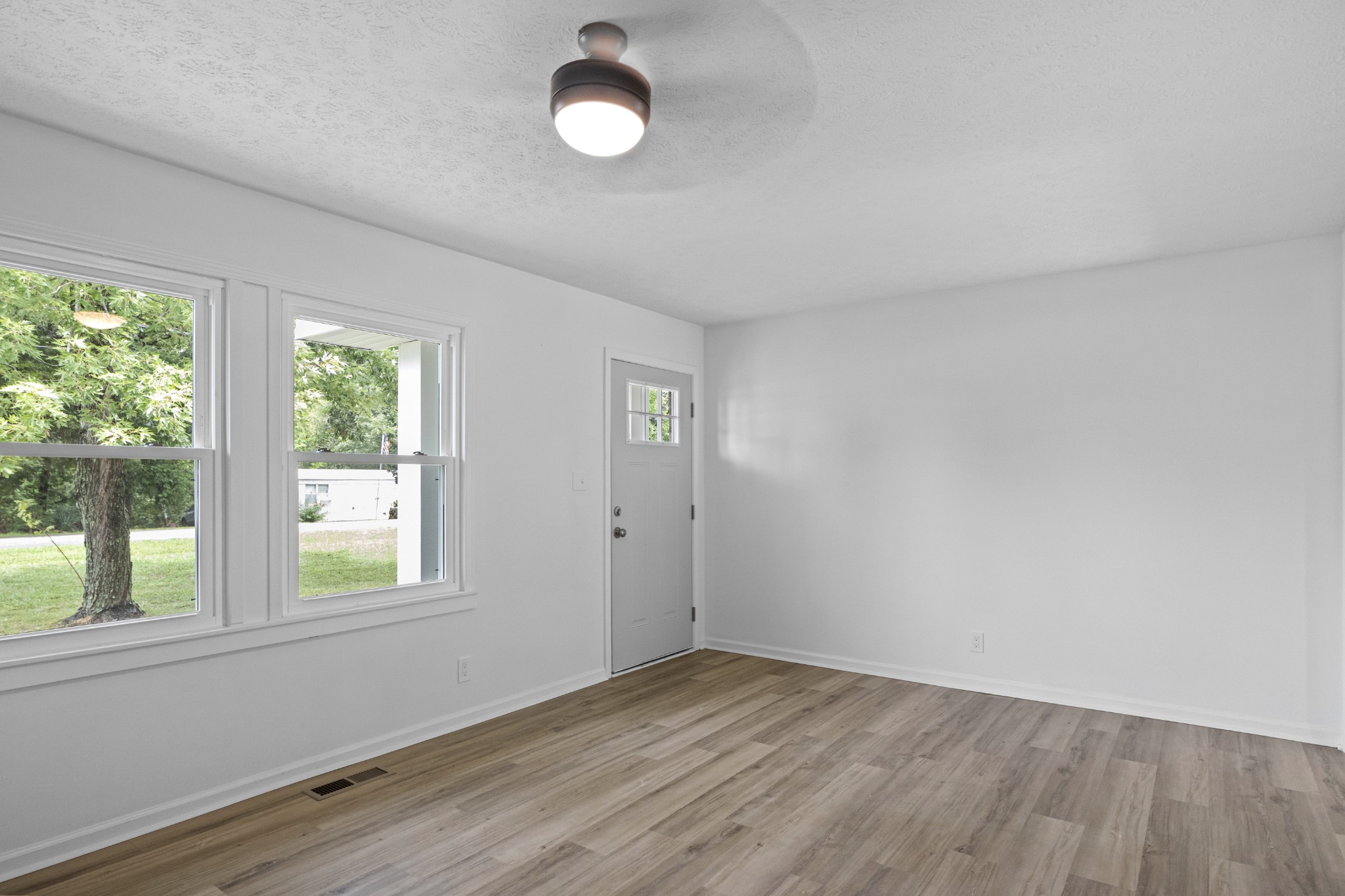 135 Hurricane Loop Tennessee Ridge, TN 37178 - Photo 22 of 29 an empty room with wooden floor and windows