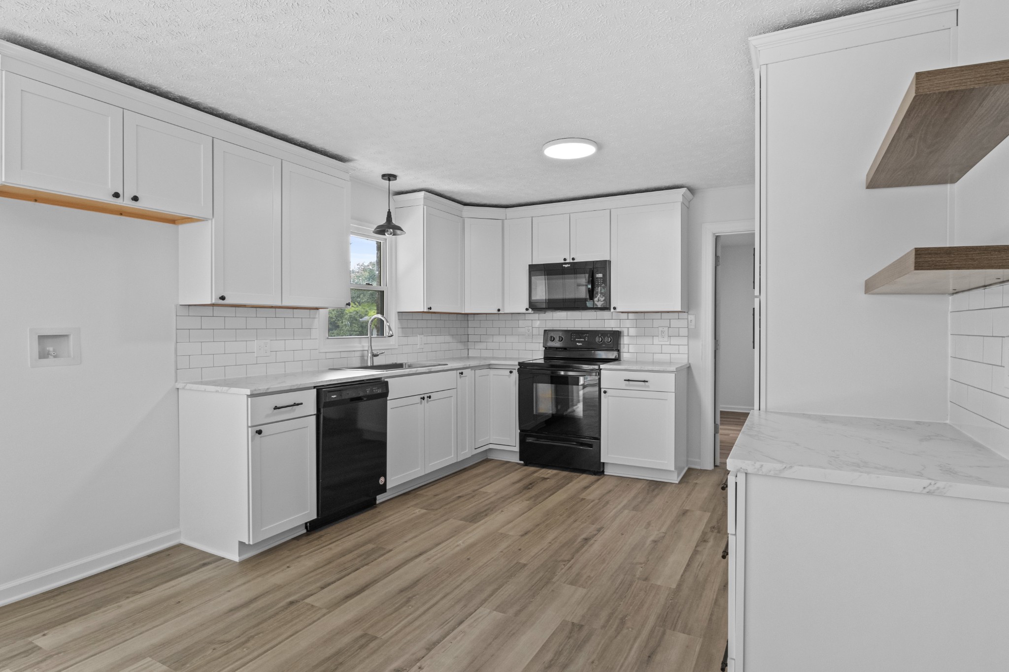 135 Hurricane Loop Tennessee Ridge, TN 37178 - Photo 3 of 29 a kitchen with a sink cabinets stainless steel appliances and a window
