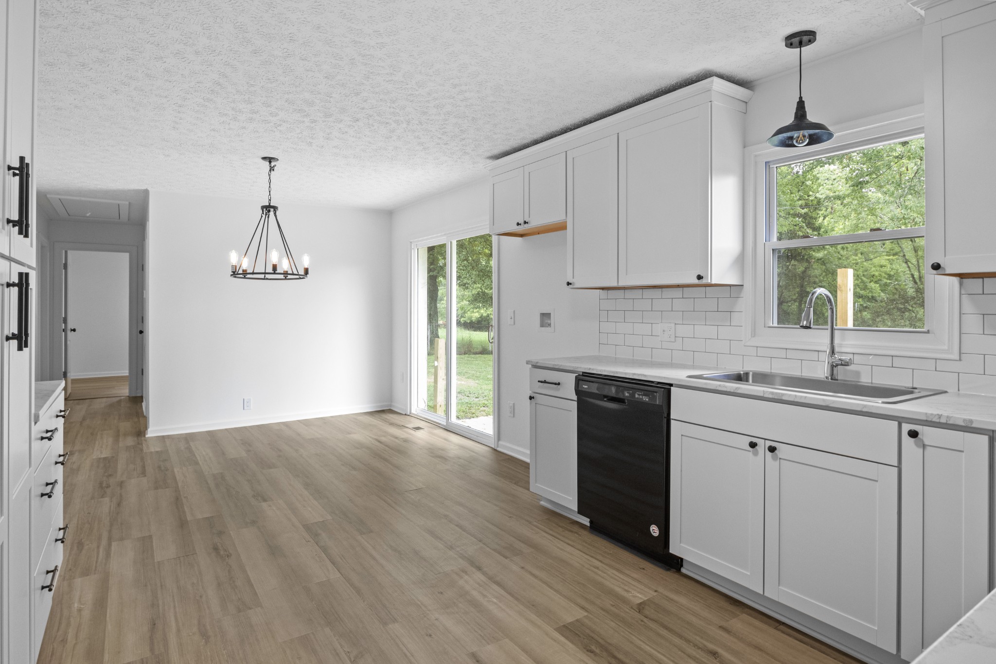 135 Hurricane Loop Tennessee Ridge, TN 37178 - Photo 6 of 29 a kitchen with wooden floors and white appliances