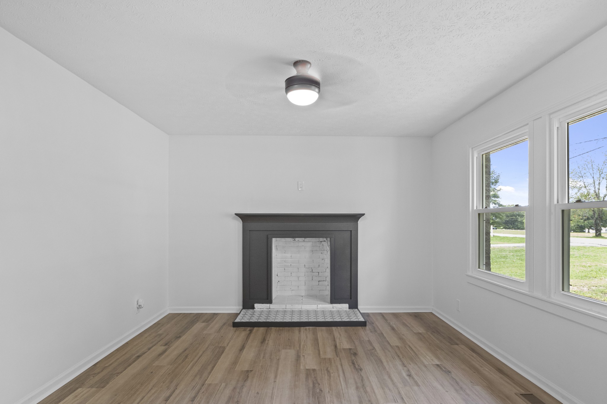 135 Hurricane Loop Tennessee Ridge, TN 37178 - Photo 7 of 29 an empty room with wooden floor and windows