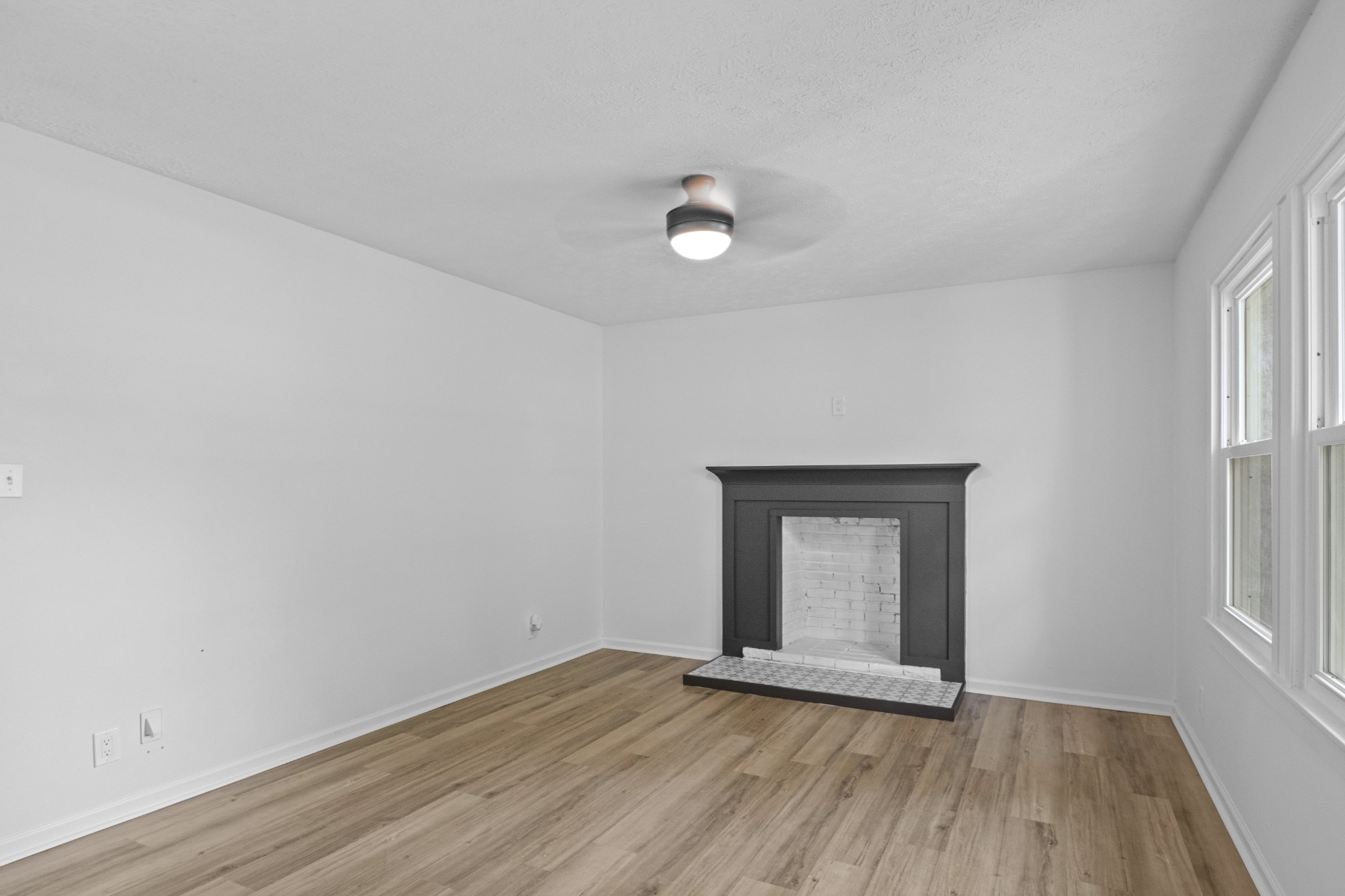 135 Hurricane Loop Tennessee Ridge, TN 37178 - Photo 8 of 29 a view of an empty room with wooden floor and a window