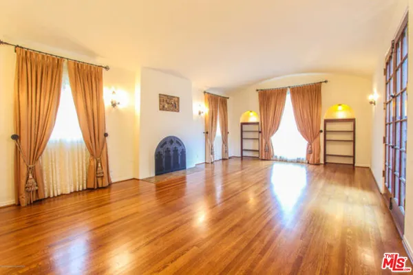 a view of a room with wooden floor and stairs