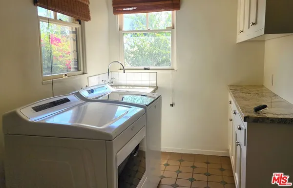 a kitchen that has a sink and a stove