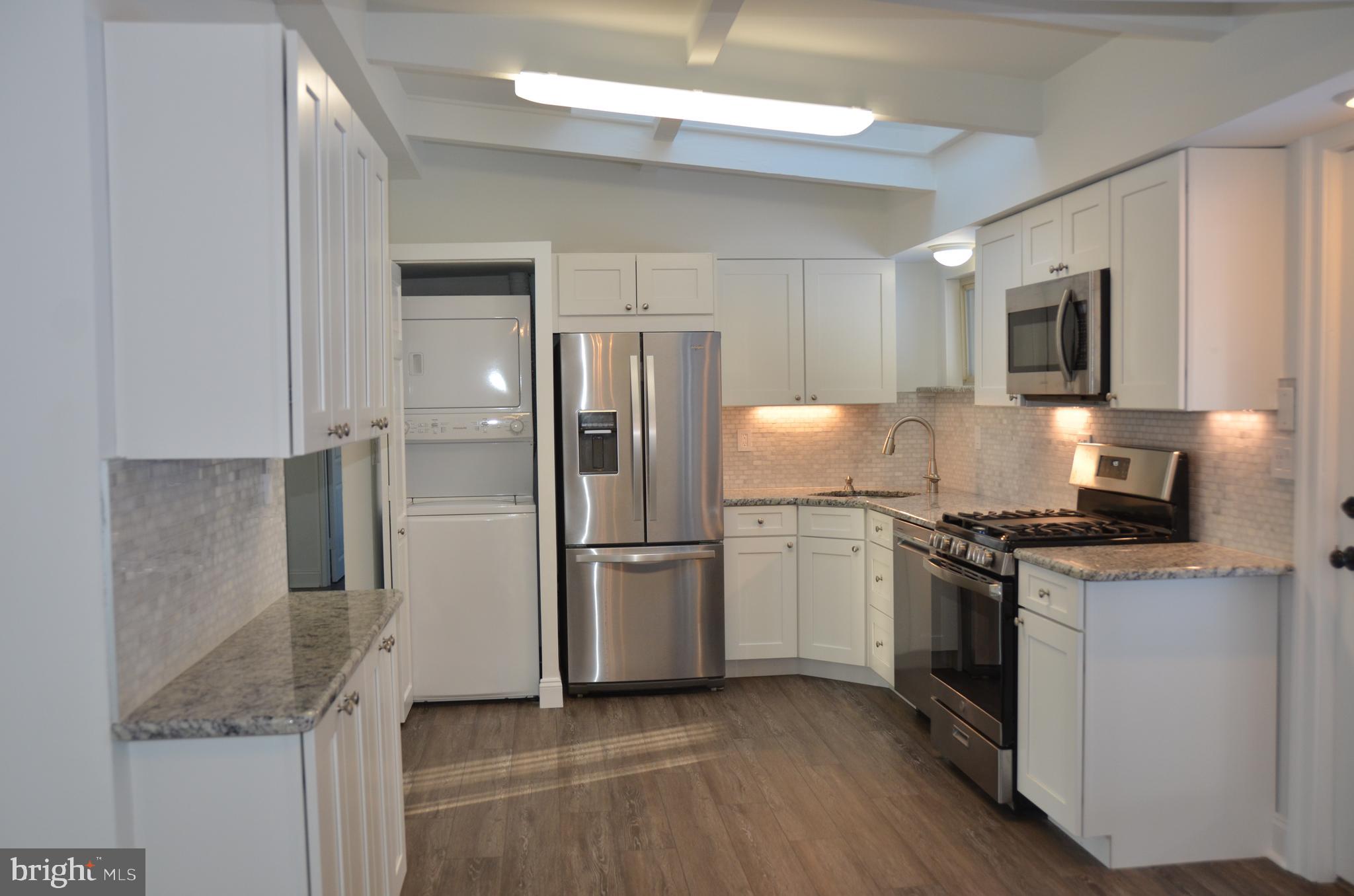 945 Croton Road Wayne, PA 19087 - Photo 4 of 13 a kitchen with stainless steel appliances granite countertop a refrigerator stove and microwave