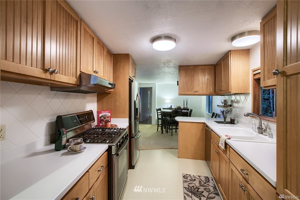 17601 Southeast 110th Street Renton, WA 98059 - Photo 6 of 11 a kitchen with a sink stove and cabinets