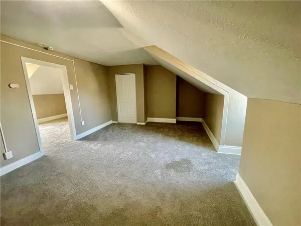 an empty room with a empty space and windows