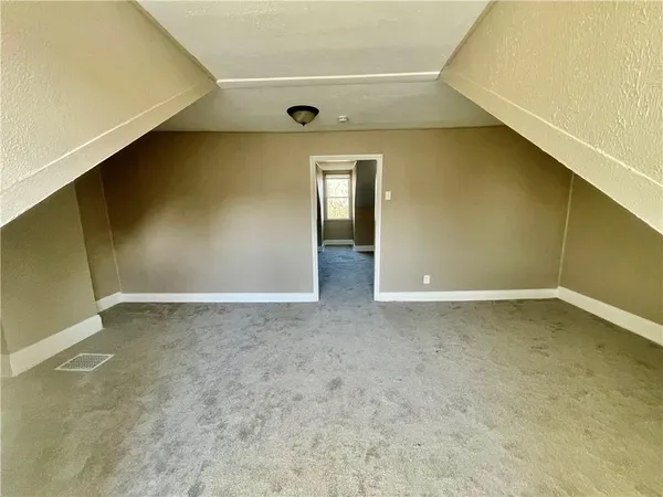 a view of a big room with closet and windows