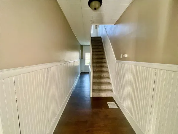 a view of a hallway with wooden floor