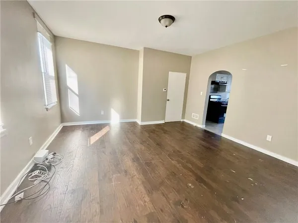 a view of a room with wooden floor and window