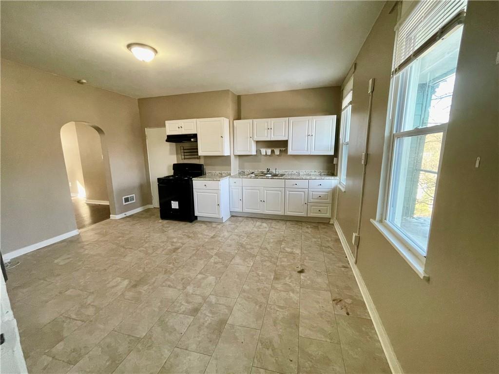 1104 Brabec Street Pittsburgh, PA 15212 - Photo 7 of 26 a large white kitchen with sink refrigerator and window