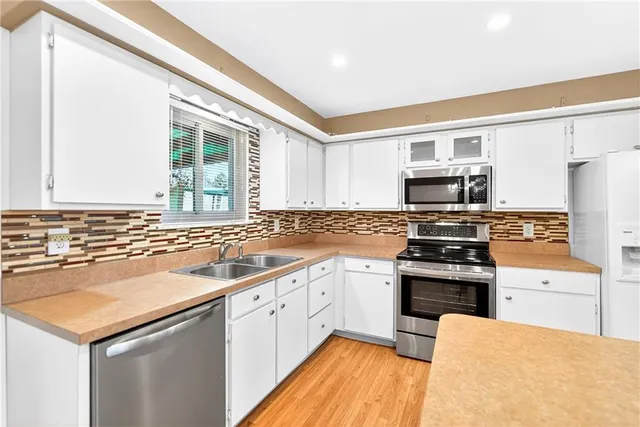 a kitchen with a sink stove and refrigerator