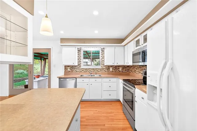 a large white kitchen with a window