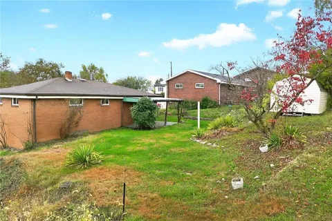 a front view of a house with a yard and a garage