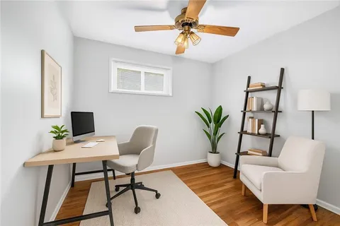 a workspace with furniture and a potted plant