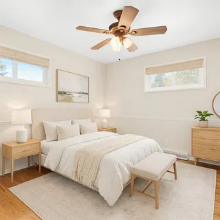 a view of a room with wooden floor and a ceiling fan