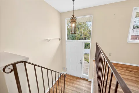 a view of entryway and hall with wooden floor