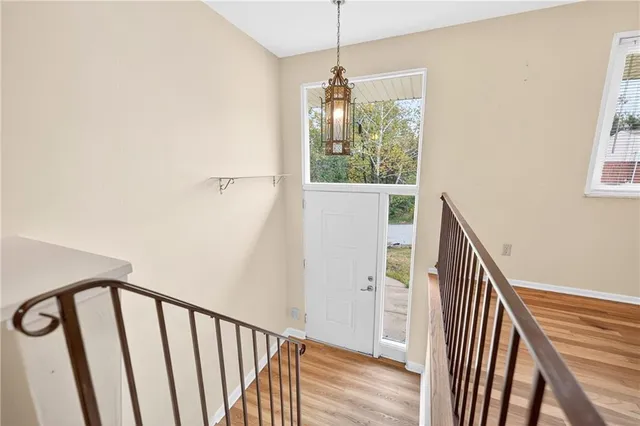 a view of entryway and hall with wooden floor
