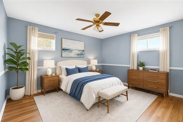 a view of a room with wooden floor and fan