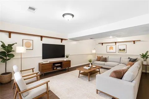 a view of a room with wooden floor