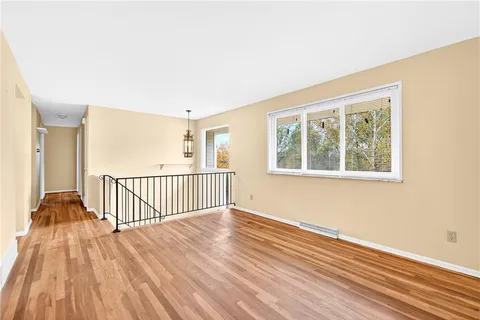 a view of a room with wooden floor and a window