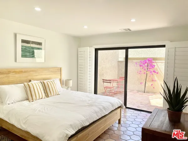 a bedroom with a large bed and a large window