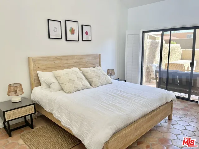 a bedroom with a bed and large window