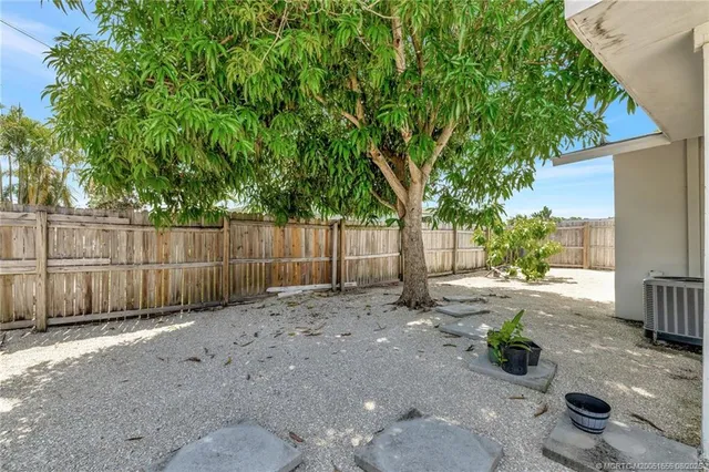 a view of a backyard with wooden fence