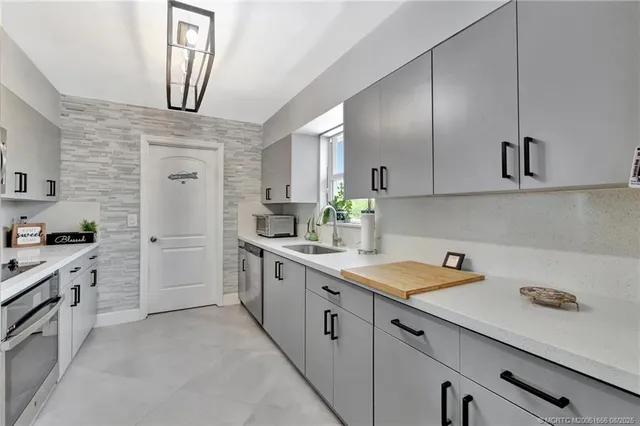 a kitchen with white cabinets and white appliances