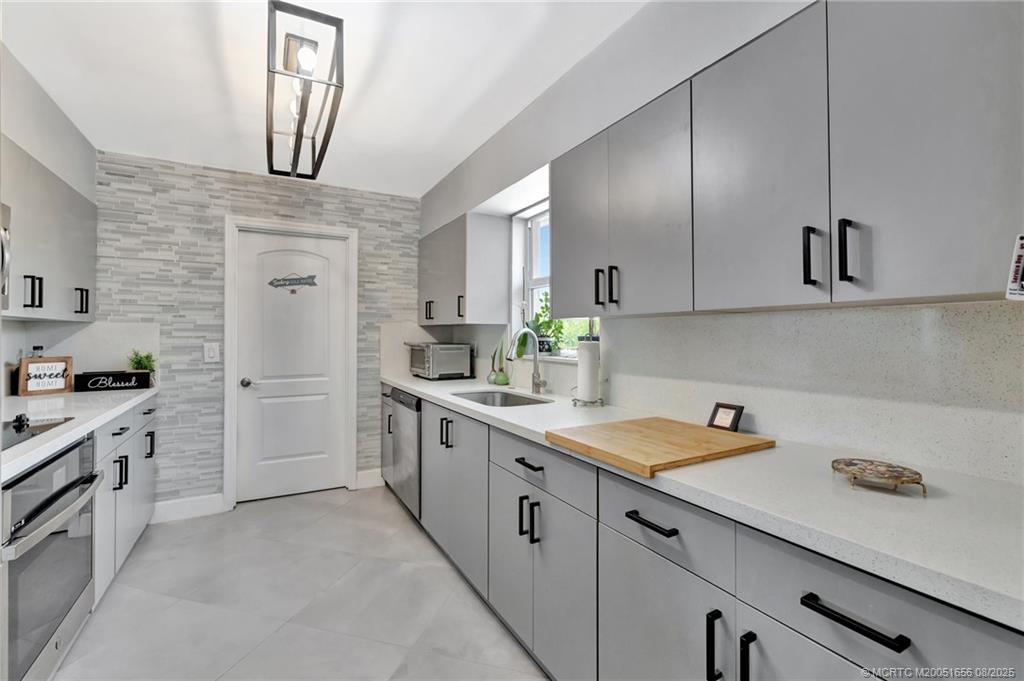 1894 Southeast Lafayette Street Stuart, FL 34997 - Photo 25 of 32 a kitchen with white cabinets and white appliances