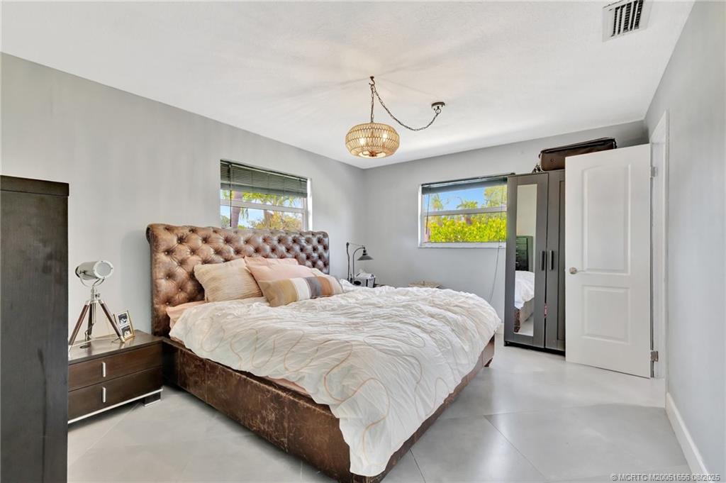 1894 Southeast Lafayette Street Stuart, FL 34997 - Photo 4 of 32 a bedroom with a bed and dresser