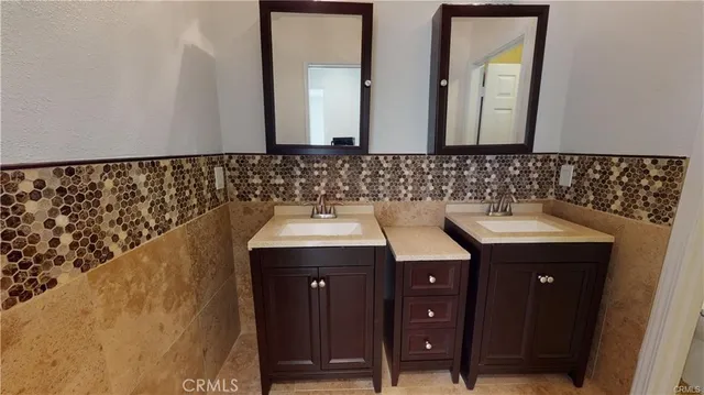 a bathroom with a sink a vanity and a mirror