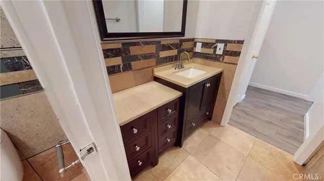 a white toilet sitting next to a white tub