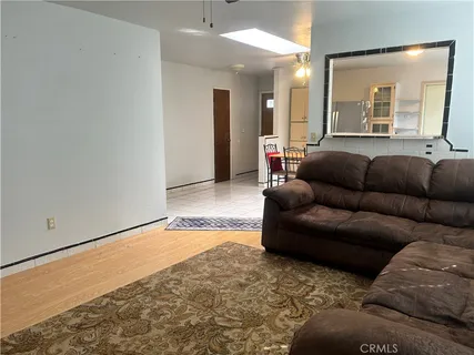 a living room with furniture and a large mirror